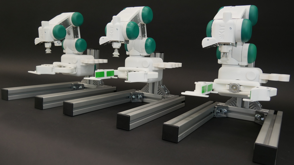 Three gripper robots standing side by side